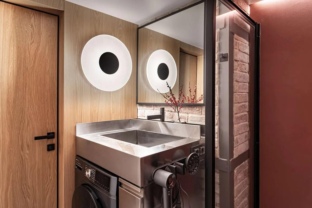 Ванная комната с раковиной из нержавейки с красной акцентной стеной